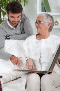 Elderly person looking at photos with son